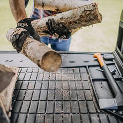 Man putting firewoods on ProLine Frogum Boot Tray